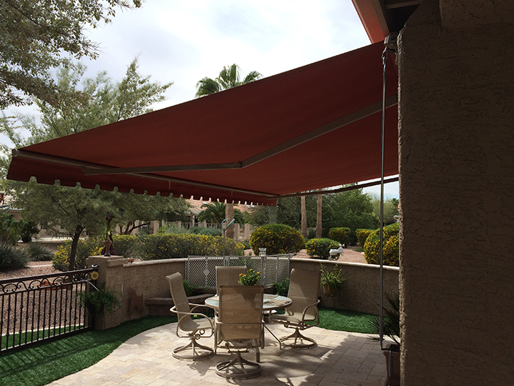 red sunchoice awning over a medium size patio